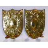 A pair of 18th century Dutch brass shield shaped twin candle wall sconces with repousse