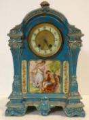 A 19th century ceramic cased mantel clock in pale blue glaze and gilt highlights, enamel and gilt