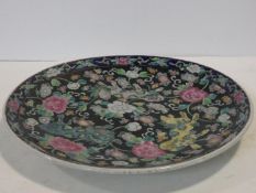 A Chinese Kangxi style, late 19th ceramic glazed and hand painted charger with lions and flowers.