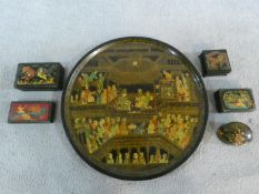 A collection of hand painted Persian/Indian gilded lacquer boxes and a similar circular tray.