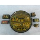 A collection of hand painted Persian/Indian gilded lacquer boxes and a similar circular tray.