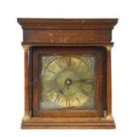 A Georgian oak cased clock with black Roman numerals on a brass dial within applied spandrels and