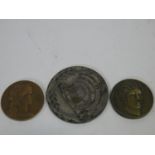 Three commemorative medals, one copper, one white metal and one brass, each with a relief design