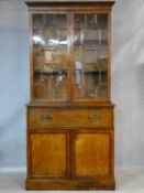 A Georgian mahogany secretaire bookcase with astragal glazed doors to the upper section enclosing