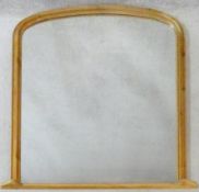 A 19th century style pitch pine arched top overmantel mirror. 120x125cm