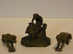 An antique brass monkey figure sitting on a tree stump with another below and a pair of brass