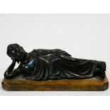 An antique bronze reclining Buddha mounted on an oak plinth. H.11 W.26 D.10cm