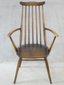 An Ercol Goldsmith Windsor armchair in elm and beech. H.96cm