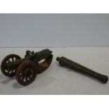 A 19th century brass desk signal cannon mounted on carved carriage along with a brass cannon barrel.
