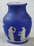 A 19th century Wedgwood Portland blue Jasperware bulbous vase with classical figures, impressed