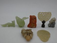 A miscellaneous collection of seven Chinese carvings in jade and coral, including figures,