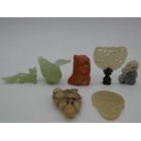 A miscellaneous collection of seven Chinese carvings in jade and coral, including figures,