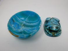 An Egyptian style turquoise glazed frog paperweight with heiroglyphs to the base along with a dyed