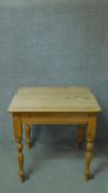 A Victorian kitchen table with scrubbed pine top on turned tapering supports. H.79 W.81 D.71cm