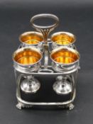 An early 19th century silver plate on copper four piece egg cup cruet on stand resting on Regency