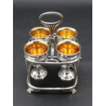 An early 19th century silver plate on copper four piece egg cup cruet on stand resting on Regency