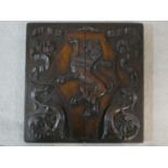 A 19th century carved oak heraldic panel depicting a Lion Rampant on a shaped shield surrounded by