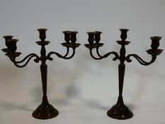 a pair of adjustable four sconce metal table candelabras in a bronzed finish. H.38cm