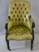 A William IV faux rosewood framed library armchair in deep buttoned pale green leather upholstery.