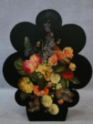A Victorian style ebonised fire screen with printed floral panel. H.77cm