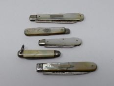 Four antique silver and mother of pearl fruit knives along with a vintage miniature celluloid pen