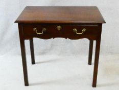 A Georgian mahogany side table fitted with frieze drawer and brass swan neck handles with shaped