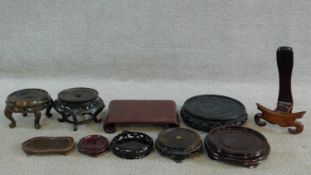 A miscellaneous collection of ten Chinese carved and pierced hardwood urn and plate stands. H.