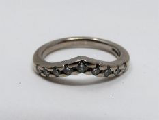 A vintage wishbone 18ct white gold and diamond half eternity ring. Set with nine round brilliant cut