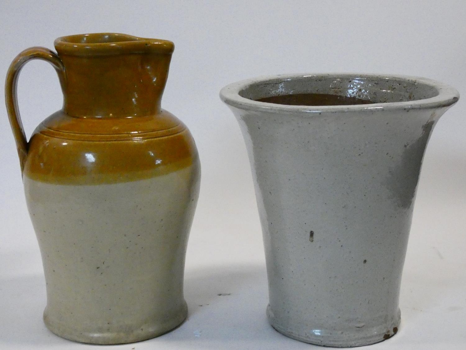 An antique stoneware honey glazed jug and a ceramic glazed plant pot. H.39cm