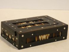 An ebonised lidded jewellery box with inlaid porcupine quills. H.5 W.17 D.11cm