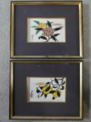 A pair of framed and glazed Oriental flower and fruit studies painted on ceramic tiles, signed and