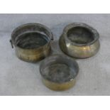 Three vintage hammered brass Indian Handis (cooking pots). One with hinged circular handles and