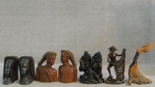 A collection of African hard wood carvings to include two pairs of head and shoulder studies, a