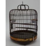 A vintage Oriental wooden bird cage with two ceramic water feeders with cherry blossom design and