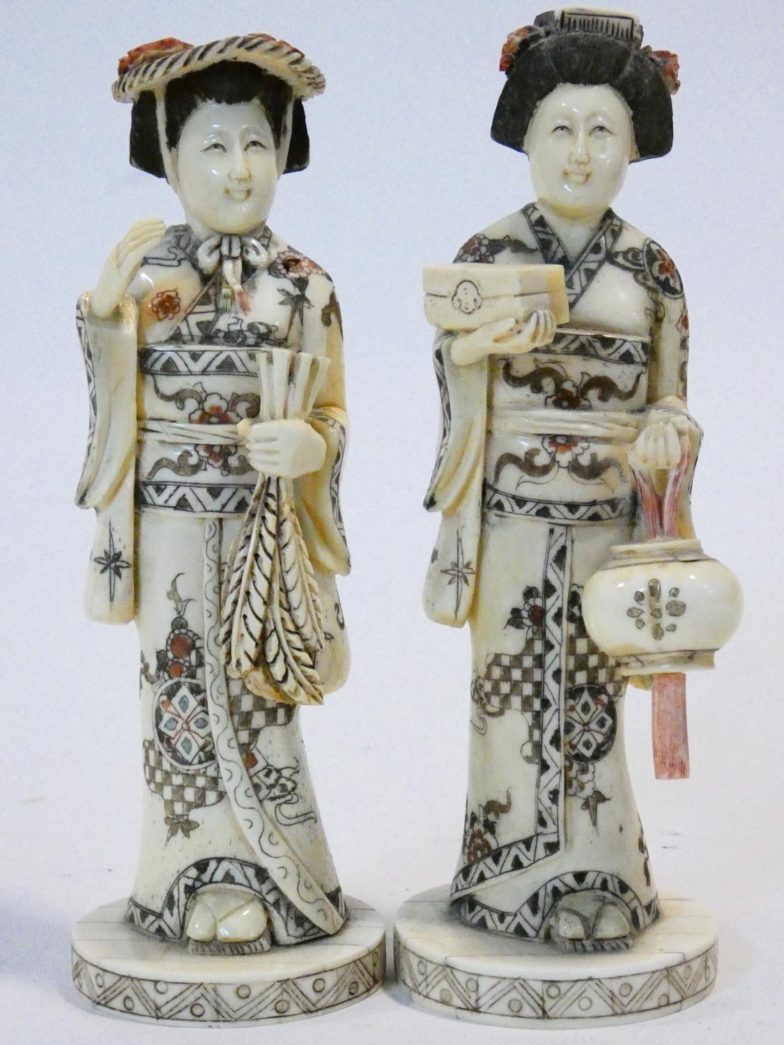 Two C.1900 Japanese carved bone geisha figures, engraved and painted, one carrying a lantern. H.20cm