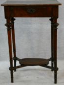 A 19th century French walnut lamp table with fitted frieze drawer on turned tapering supports united