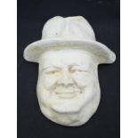 A wall hanging moulded plaster cast, face mask of Winston Curchill. 20x16cm