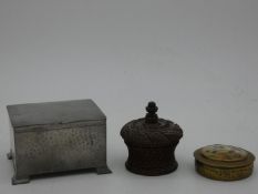 A vintage hammered pewter lidded box, a carved treen trinket box with turned screw down lid and a