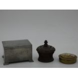A vintage hammered pewter lidded box, a carved treen trinket box with turned screw down lid and a