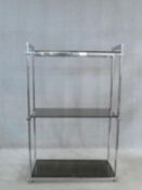 A vintage 1970's three tier etagere with smoked grey glass tiers on a chrome frame. H.124 W.86 D.