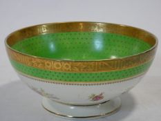 An antique Irish Arklow hand painted porcelain bowl with floral design, apple green band with gilt