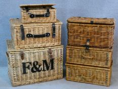 A set of three graduating wicker hamper baskets, one with Fortnum and Mason logo along with three