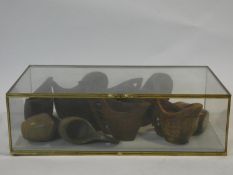 A glass cased collection of carved wooden Scandinavian jugs and vessels along with a carved Dodo.