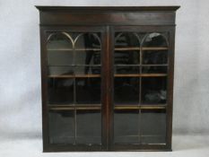 A Georgian mahogany bookcase section with astragal glazed doors enclosing bookshelves. H.119 W.113
