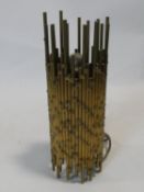 An abstract brass rod table uplighter of sculptural design. H.33cm