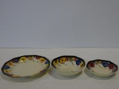 Three hand painted Royal Doulton 'Pansy' design pieces, featuring a black band, Yellow, Red & Blue