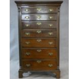 A late 19th century Georgian style mahogany tallboy chest of seven graduated drawers flanked by