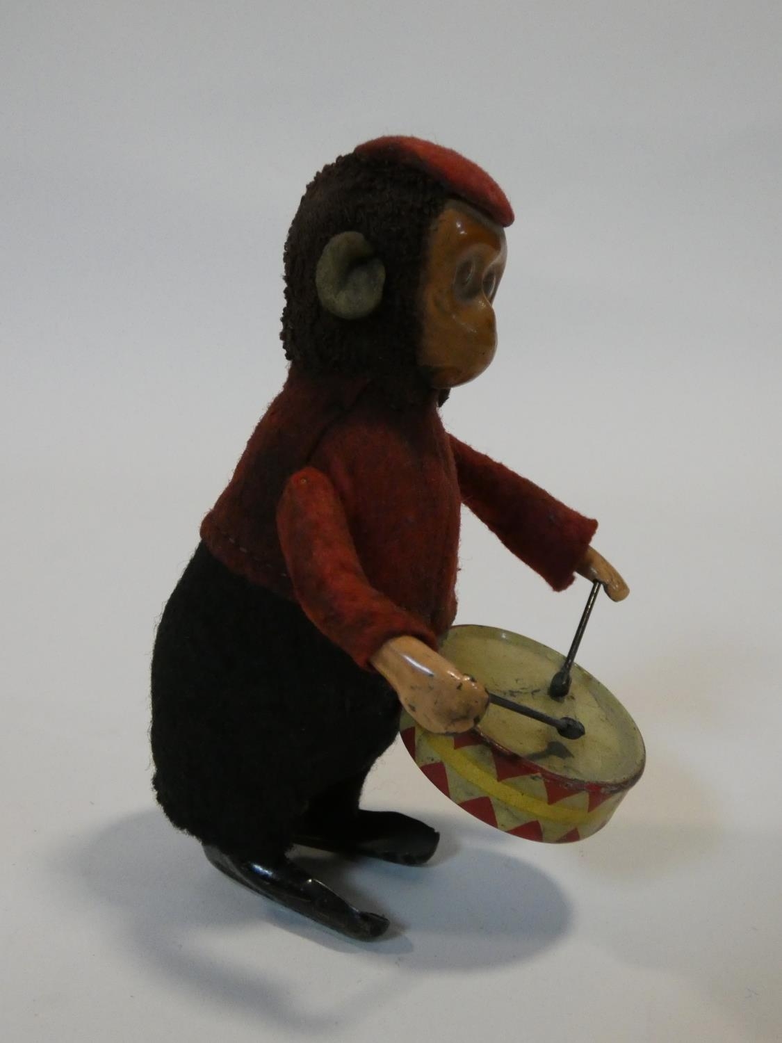 A Schuco patent drumming monkey clockwork toy, with makers mark to foot. No Key. H.11cm - Image 2 of 7