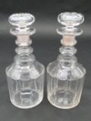 A pair of cut and facetted Georgian decanters of mallet form with three ring necks and original