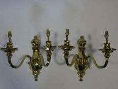 A pair of heavy solid brass Dutch style two branch wall candelabras with bakelite collars. H.31cm.